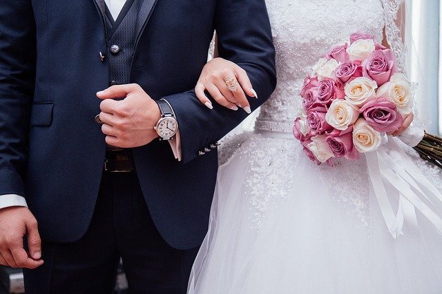 couple holding hands in front of the camera